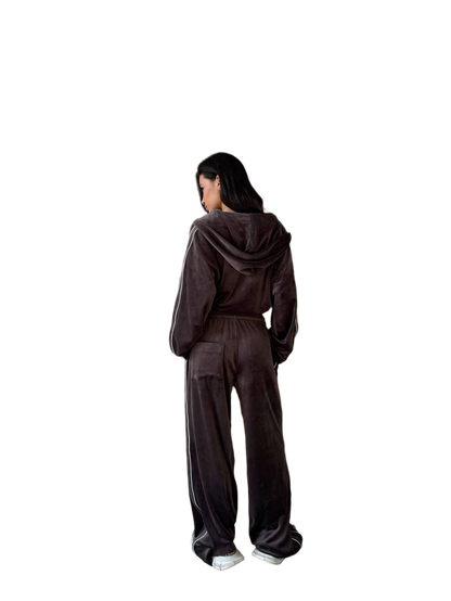 Person wearing a brown tracksuit from behind on a white background