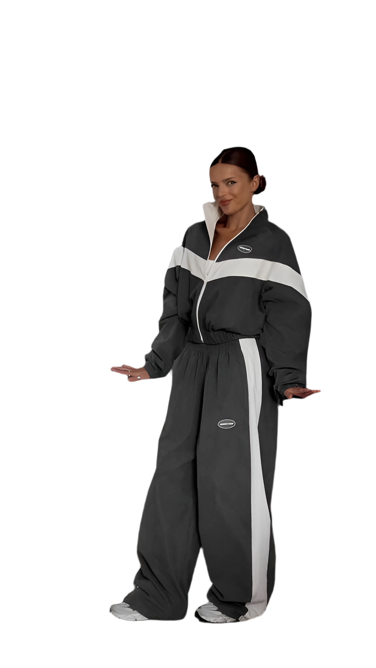 Person wearing a black and gray jumpsuit with white stripes on a white background