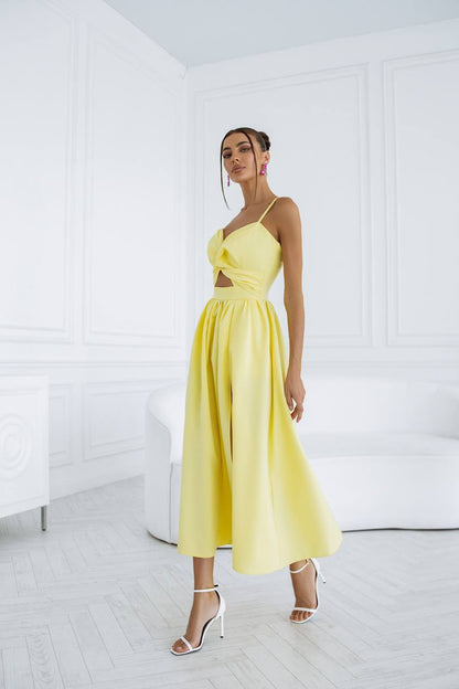 Woman wearing a yellow dress in a minimal white room