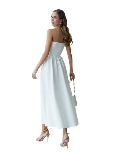 Woman wearing a strapless white dress on a white background