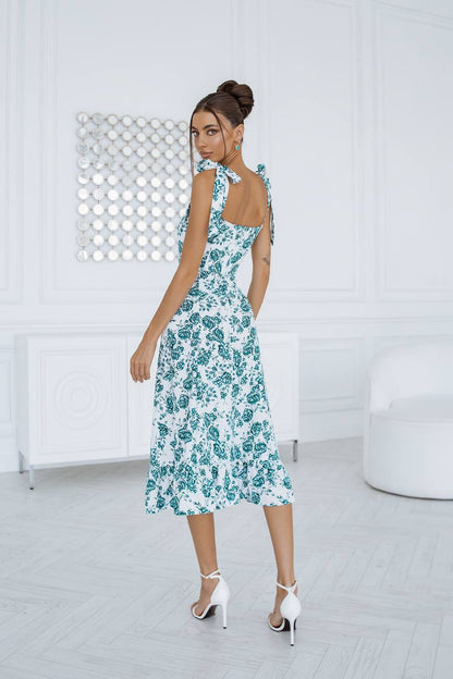 Woman wearing a floral dress in a minimalistic room