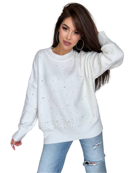 Woman wearing a white sweater with decorative elements on a white background