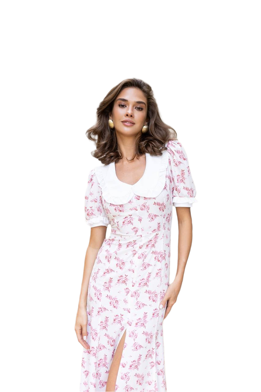 Woman wearing a white dress with pink floral pattern on a white background