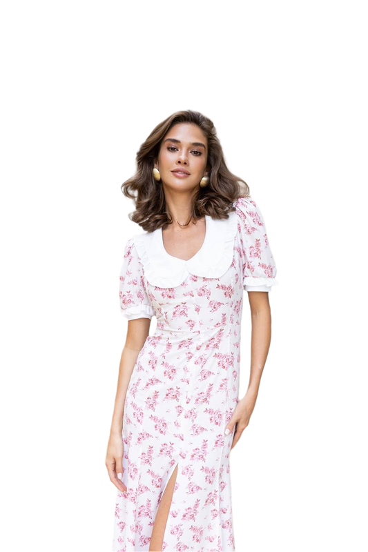 Woman wearing a white dress with pink floral pattern on a white background