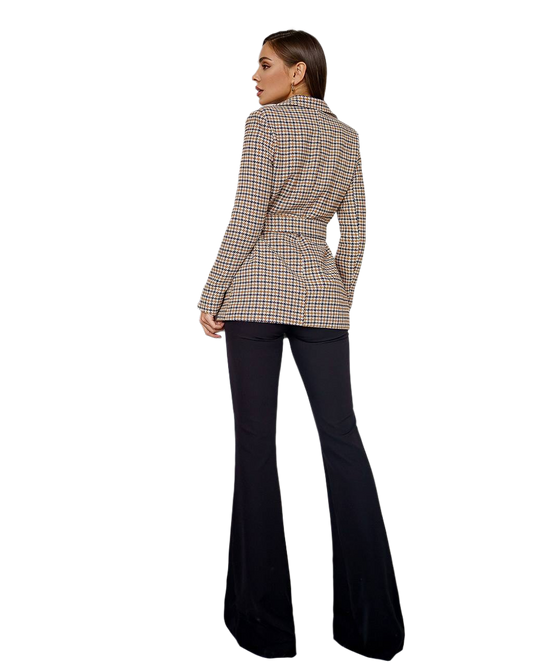 Person wearing a plaid blazer and black flared pants on a white background