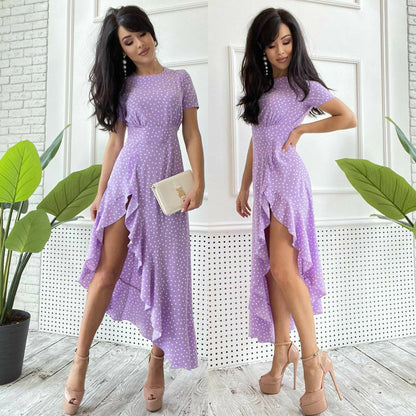 Woman wearing a purple dress with a white background and plants.