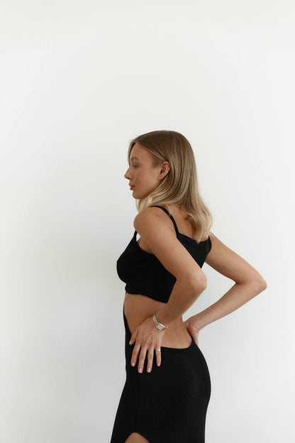 Woman wearing a black dress against a white background