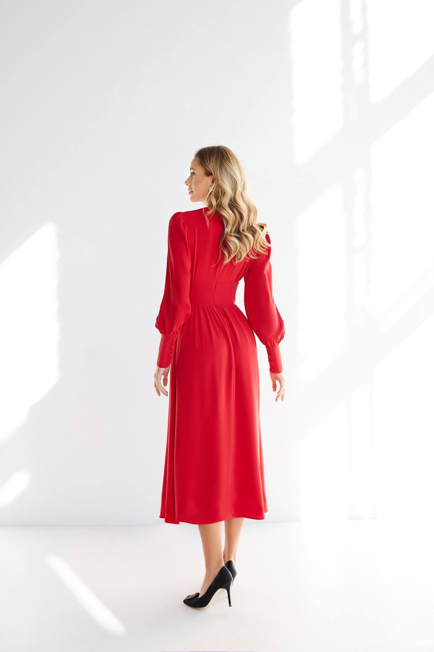 Woman wearing a red dress against a white background