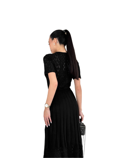 Woman wearing a black dress with a white background