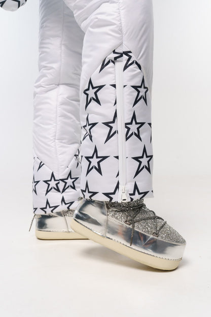 White puffer pants with star patterns and silver glittery boots on a white background