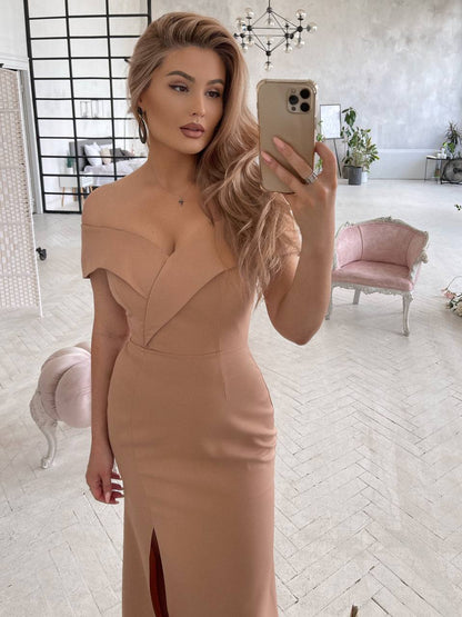 Woman taking a mirror selfie wearing a beige dress in a stylish room.