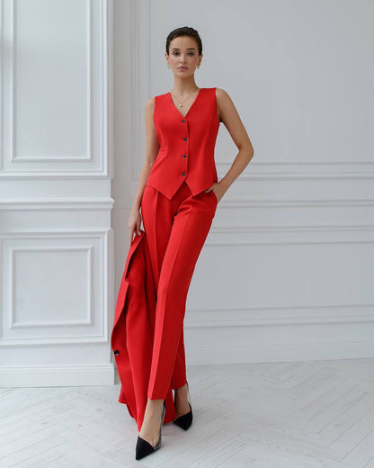 Woman wearing a red outfit with a white wall background