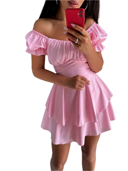 Pink off-shoulder dress worn by a person on a white background