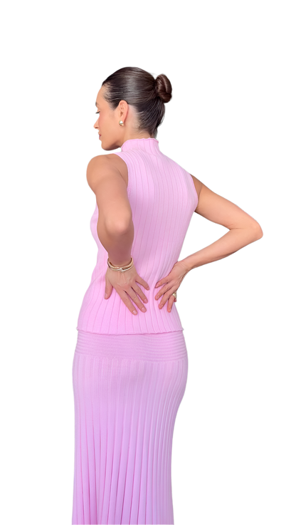 Woman wearing a pink dress on a white background