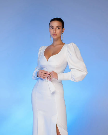 Woman wearing a white dress with puffed sleeves against a blue background