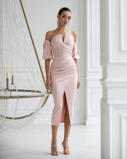 Woman wearing a pink off-shoulder dress in an elegant interior setting