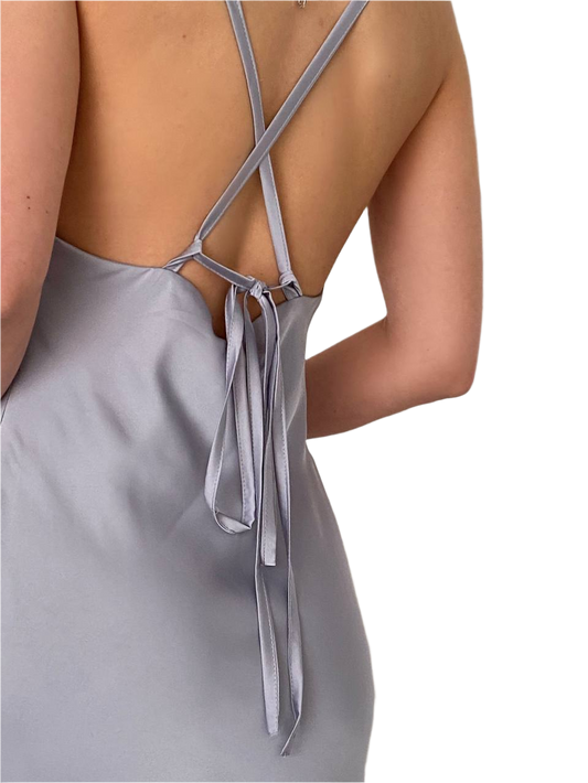 Gray dress with thin straps and a tie detail on a white background