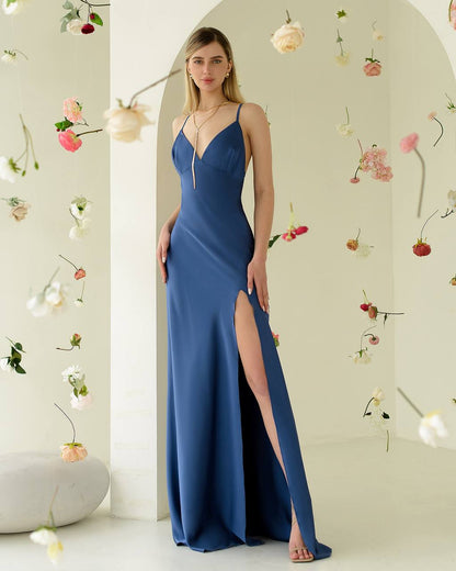 Woman wearing a blue evening gown with floral decorations in the background