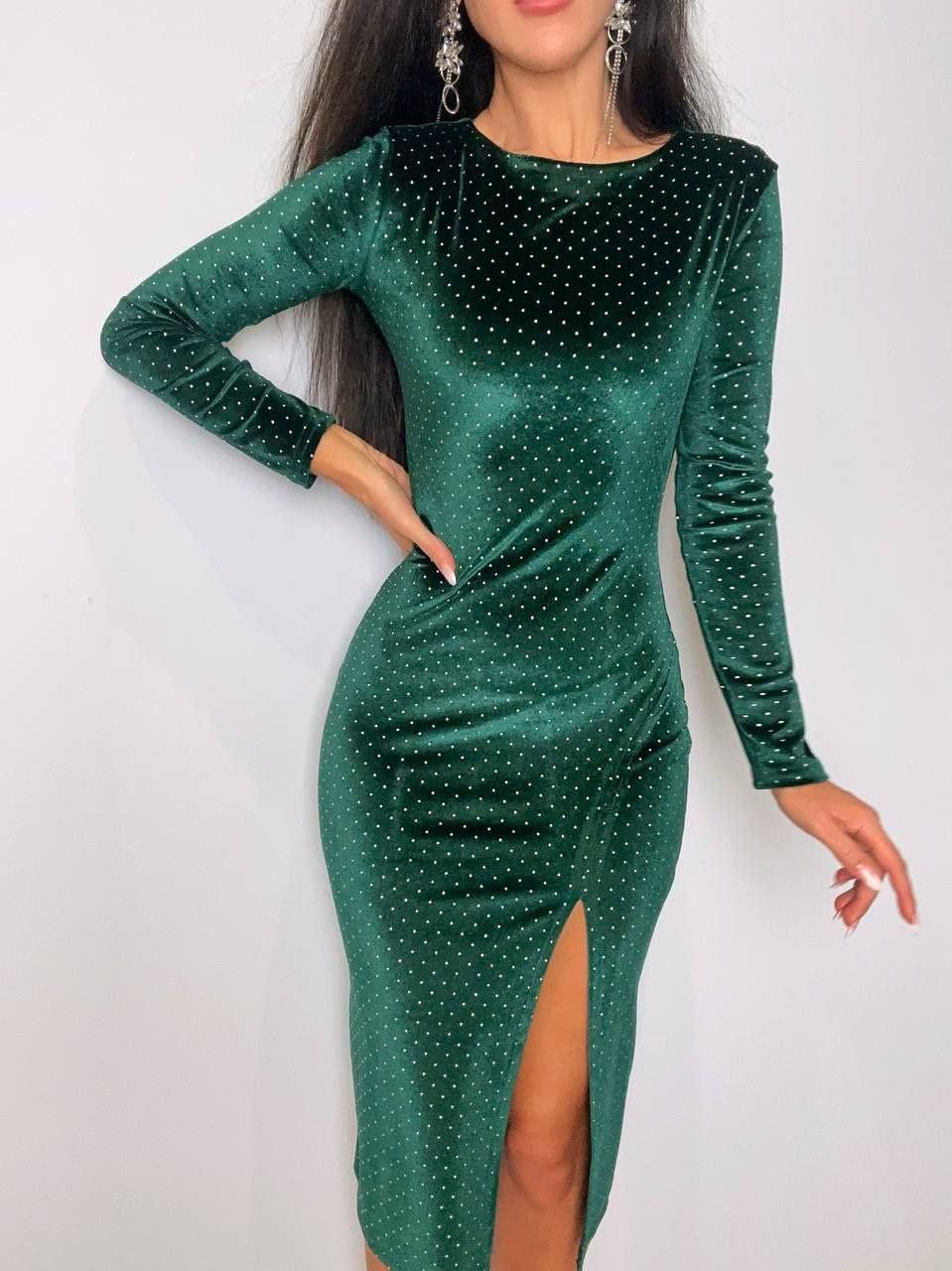Green dress with long sleeves and a high slit on a white background