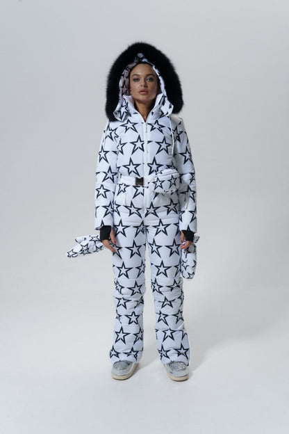 Person wearing a black and white star-patterned onesie on a plain background
