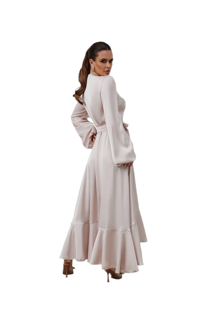 Woman wearing a long, light-colored dress on a white background