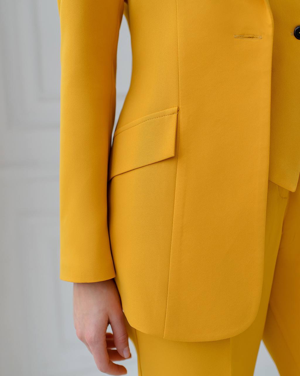 Yellow suit jacket on a plain background