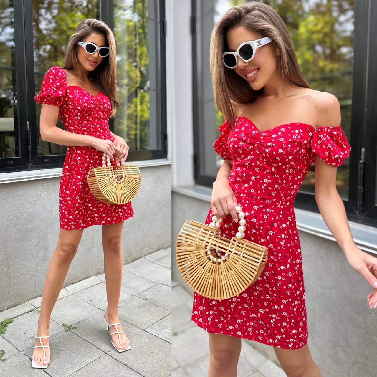 Woman in a red floral dress holding a straw bag outdoors.
