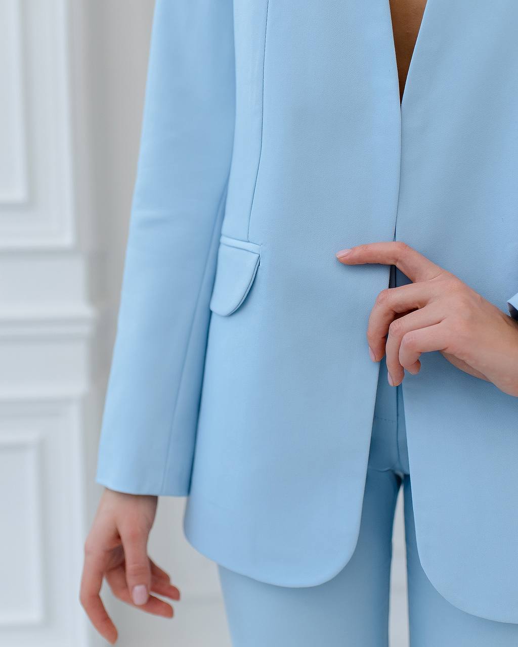 Light blue suit worn by a person against a white background