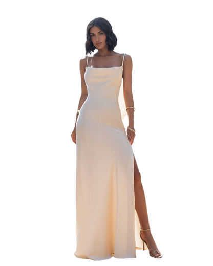 Woman wearing a beige evening gown with a slit on a white background