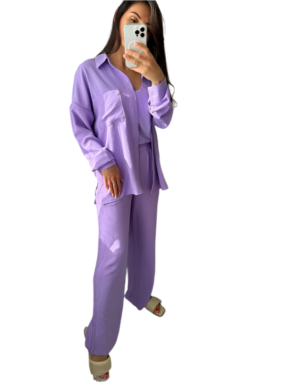 Person wearing a lavender pajama set taking a mirror selfie.
