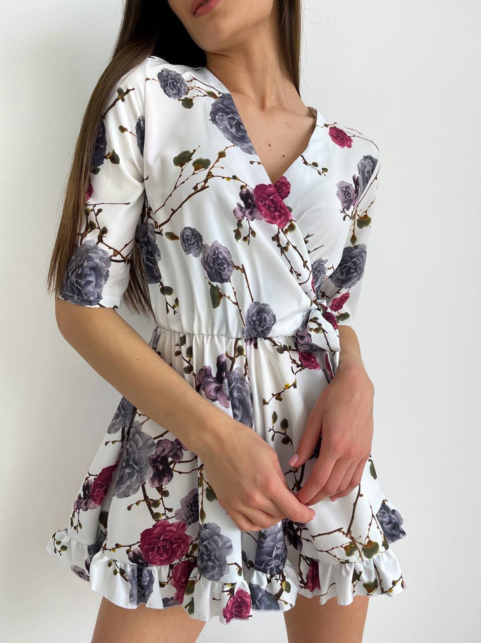 Woman wearing a floral dress with a white background