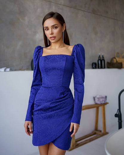 Woman wearing a blue dress in a bathroom setting