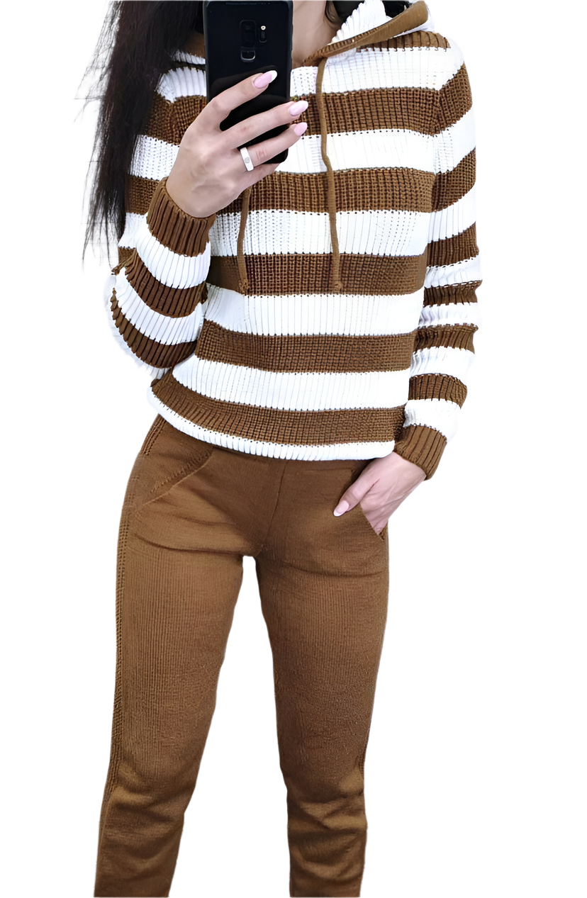 Person wearing a brown and white striped sweater with brown pants on a white background