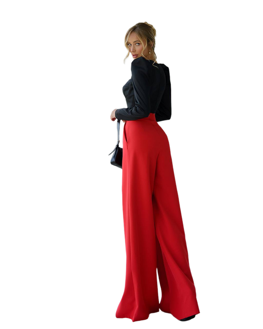 Woman wearing a black top and red wide-leg pants on a white background