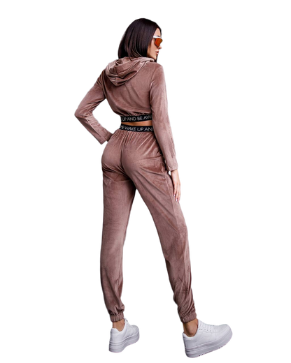 Woman wearing a brown tracksuit with a hood on a white background