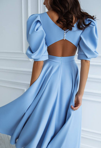 Light blue evening gown with puff sleeves on a white background