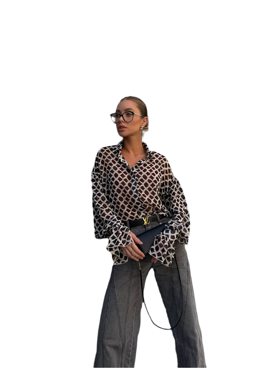 Person wearing a leopard print shirt and gray pants on a white background