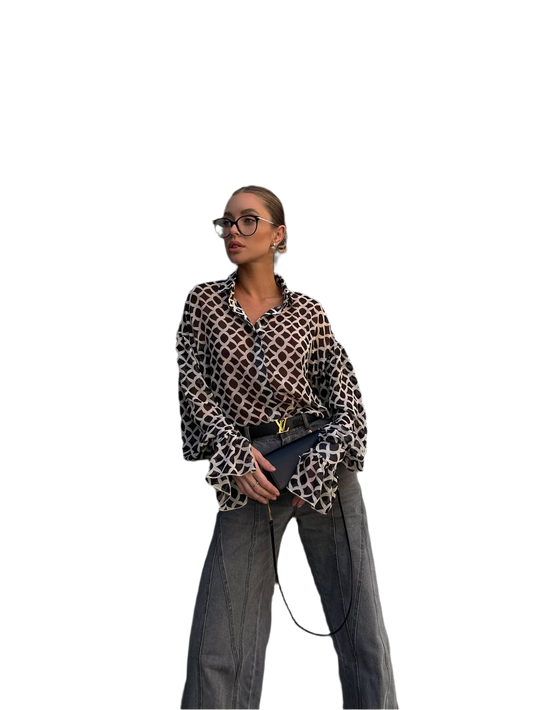 Person wearing a leopard print shirt and gray pants on a white background