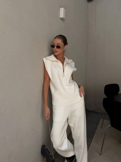Person wearing a white outfit in a minimal indoor setting