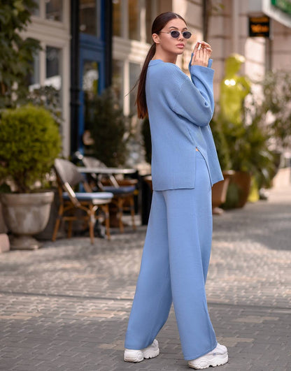 Woman in a blue outfit standing on a street with plants and tables in the background