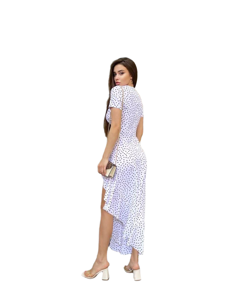 Woman wearing a white dress with black polka dots on a white background