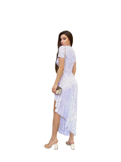 Woman wearing a white dress with black polka dots on a white background