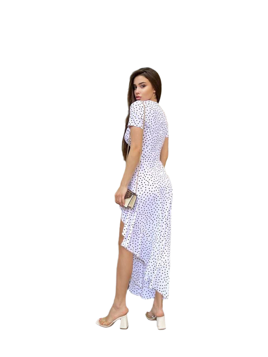 Woman wearing a white dress with black polka dots on a white background