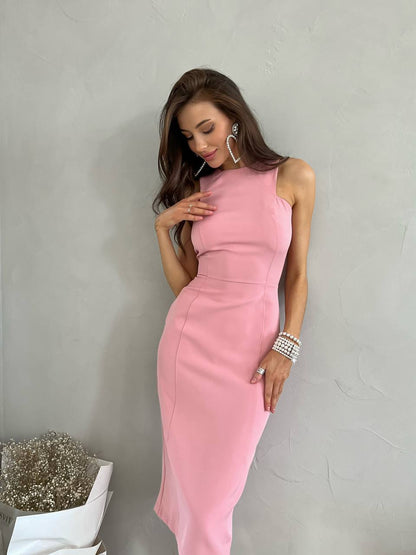 Woman wearing a pink dress against a plain background