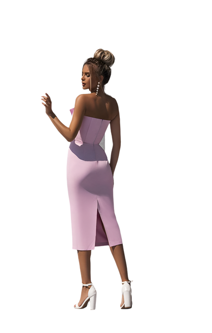 Woman wearing a strapless pink dress with a white background