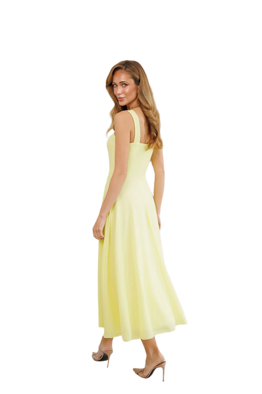 Woman wearing a light yellow dress on a white background