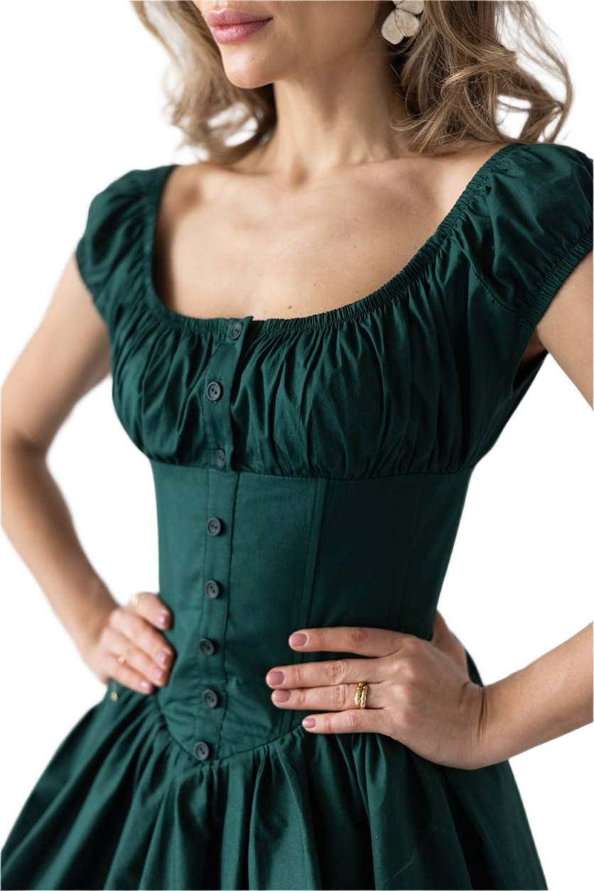 Green dress with button details on a white background