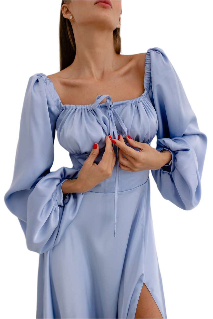 Woman wearing a light blue dress with long sleeves on a white background
