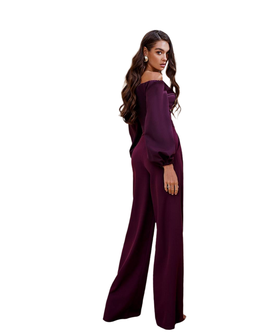 Woman wearing a dark purple jumpsuit on a white background