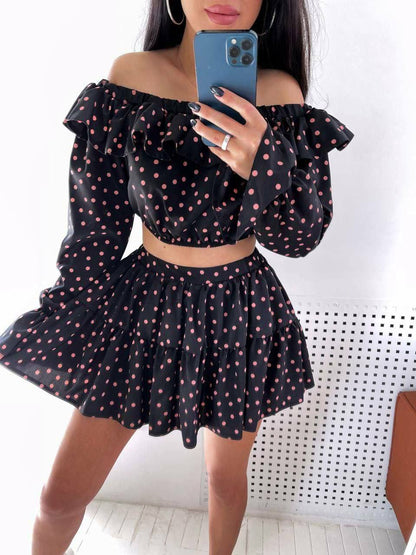 Person wearing a black polka dot outfit with a white background